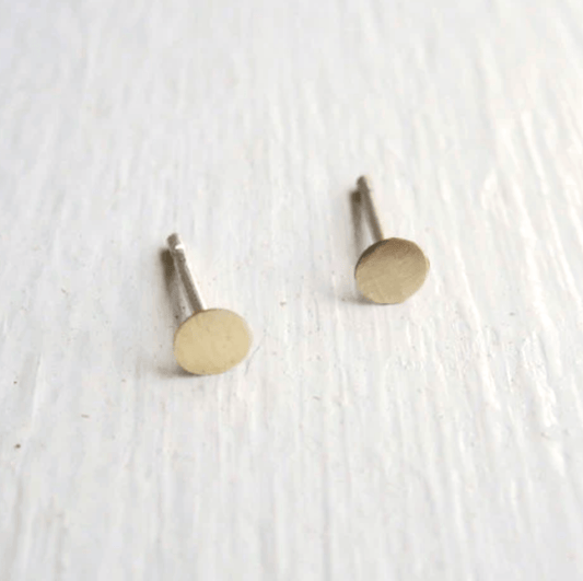 Matte brass earrings displayed flat on a neutral background