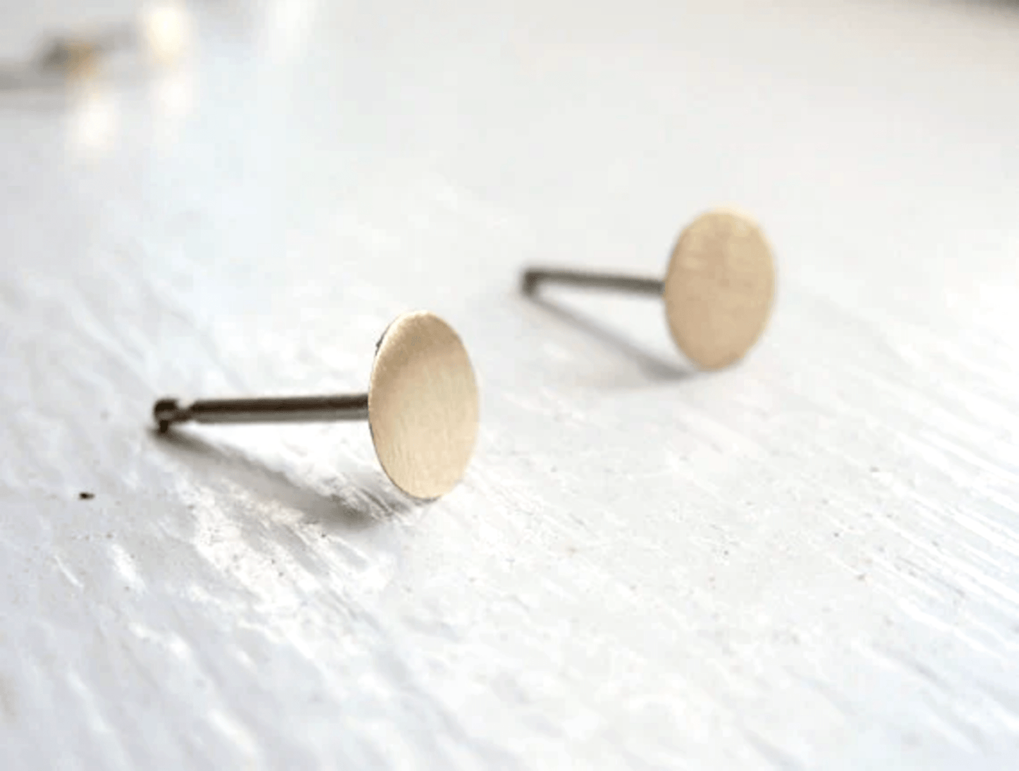 Matte finish 5mm brass circle stud earrings with sterling silver posts.