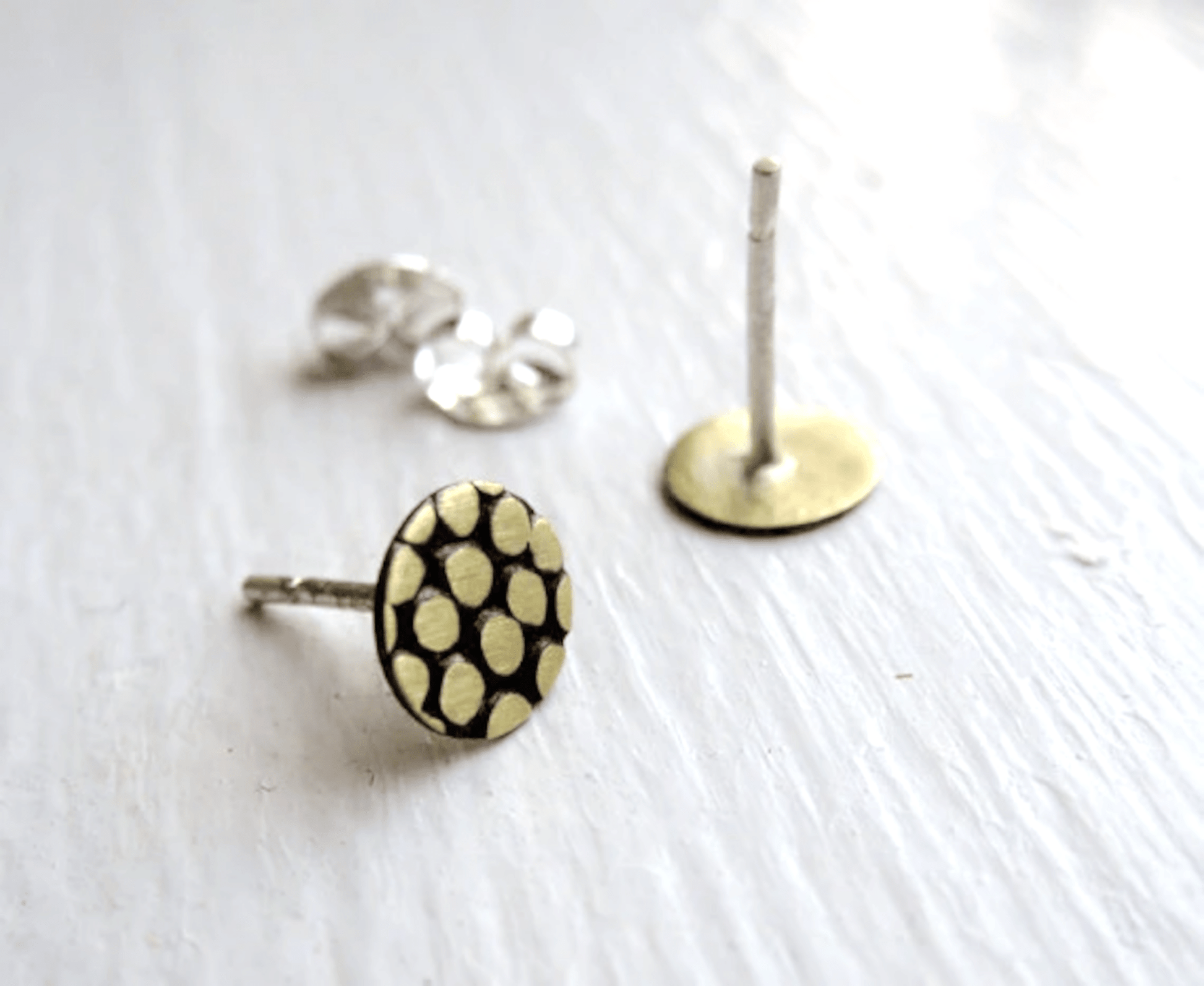 A close-up shot of the sterling silver posts and butterfly backs, emphasizing quality and craftsmanship.