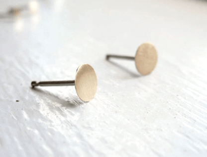 Matte finish 5mm brass circle stud earrings with sterling silver posts.